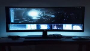 A sleek dark workspace with glowing blue accent lights and a futuristic dashboard displaying blazing performance metrics.