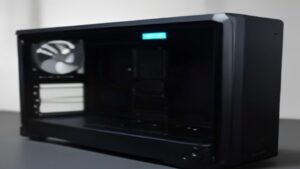 A sleek gaming setup with a monitor displaying Windows 12 performance graphs, RGB keyboard, and high-end GPU